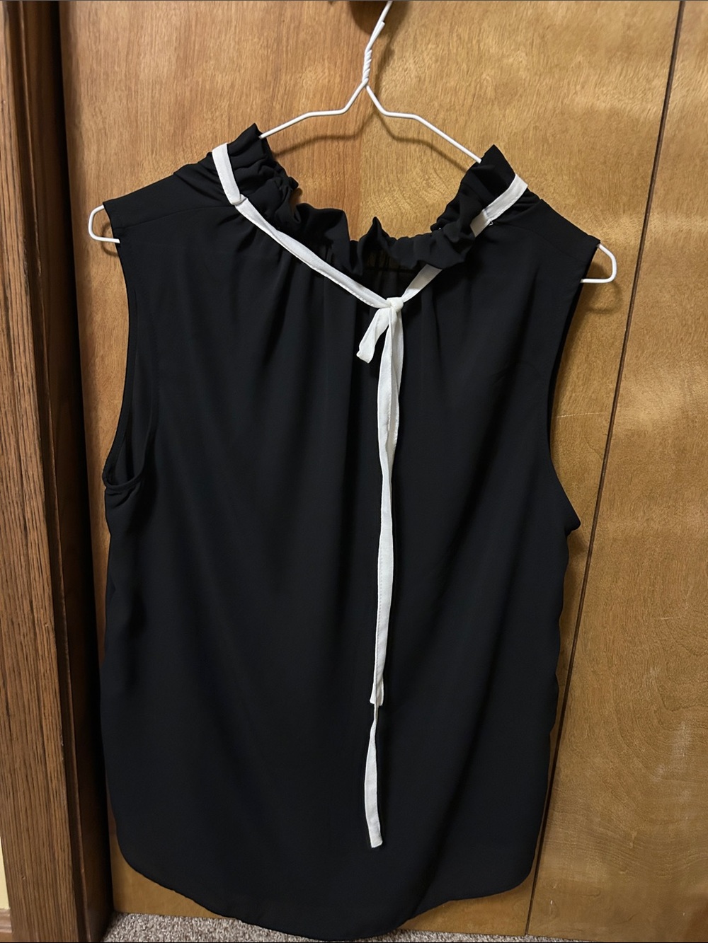 Sleeveless Ruffle Neck Tie-Back Top in Black with White Trim